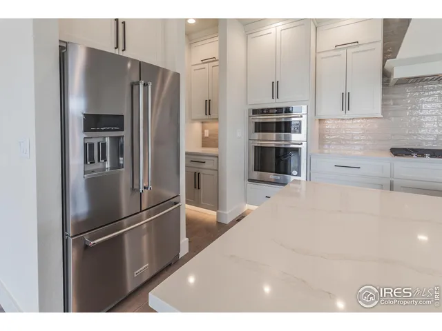 a kitchen with kitchen island a sink stainless steel appliances and cabinets