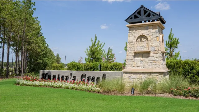 a view of front of house with sign board and yard