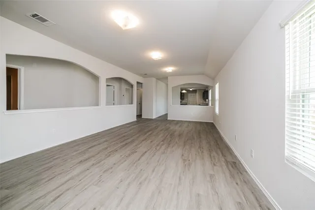 wooden floor in an empty room with a window