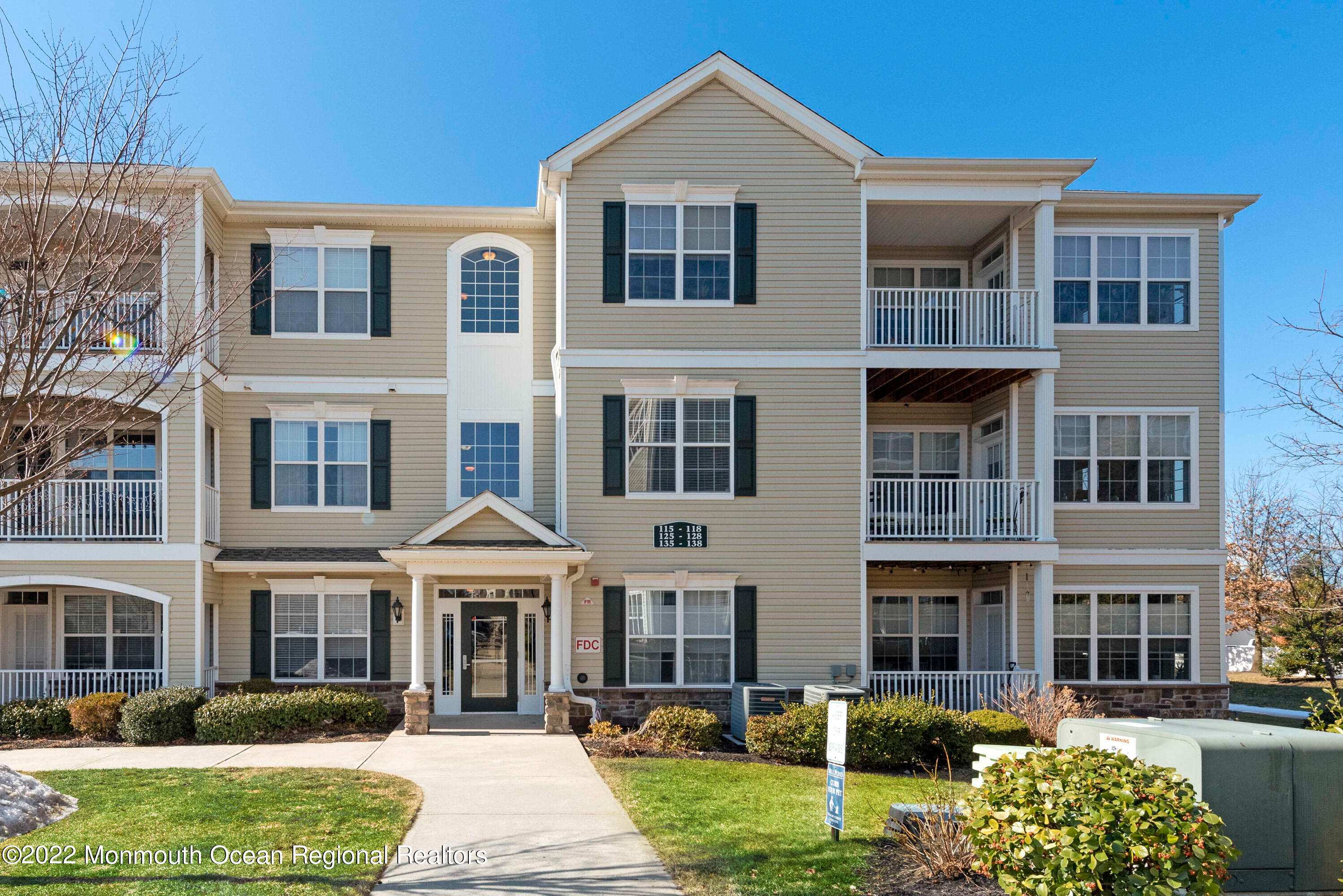 136 Mill Pond Way, Unit 22 Eatontown, NJ 07724 - Photo 1 of 29 a front view of a residential apartment building with a yard