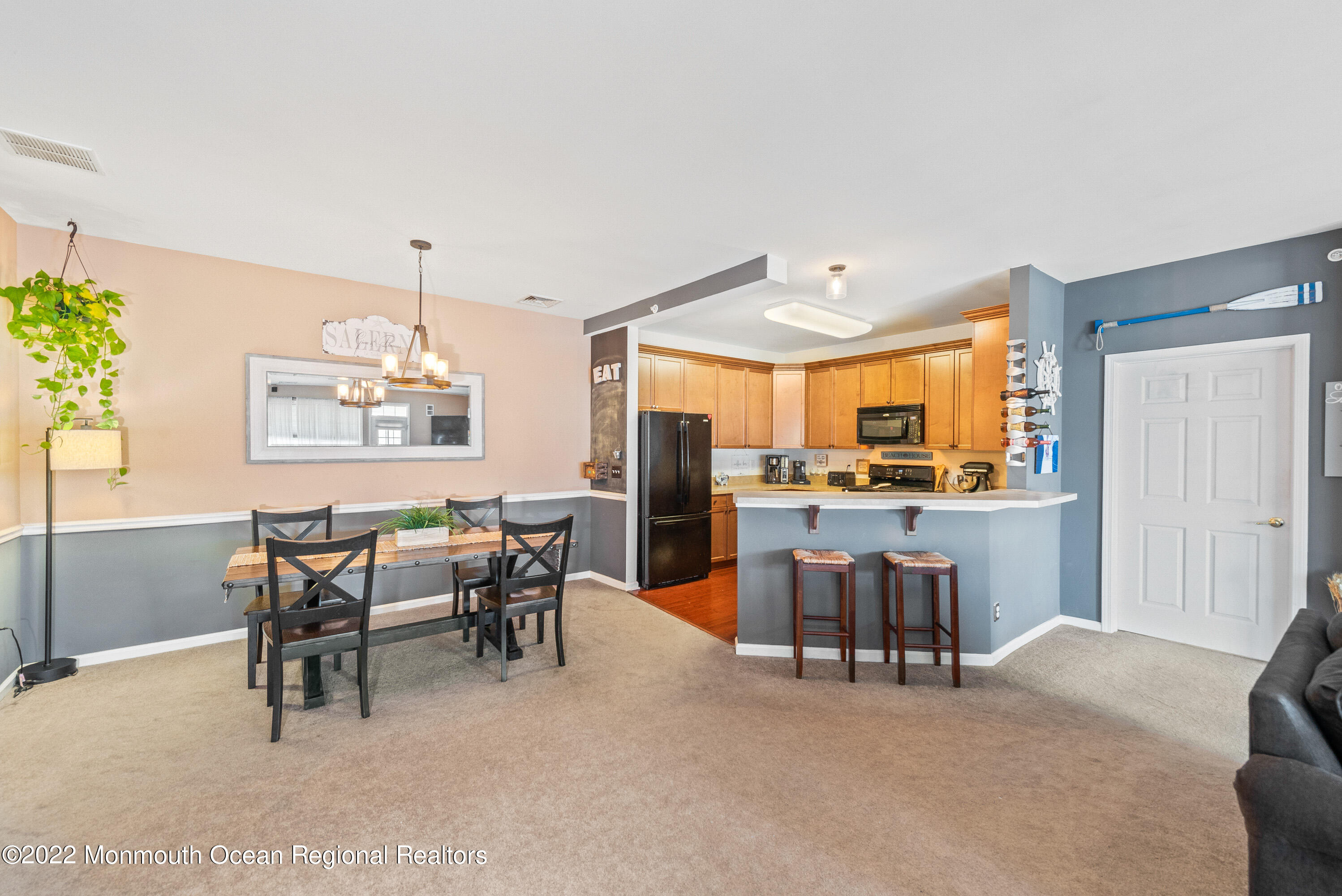 136 Mill Pond Way, Unit 22 Eatontown, NJ 07724 - Photo 11 of 29 a view of a dining room with furniture and chandelier