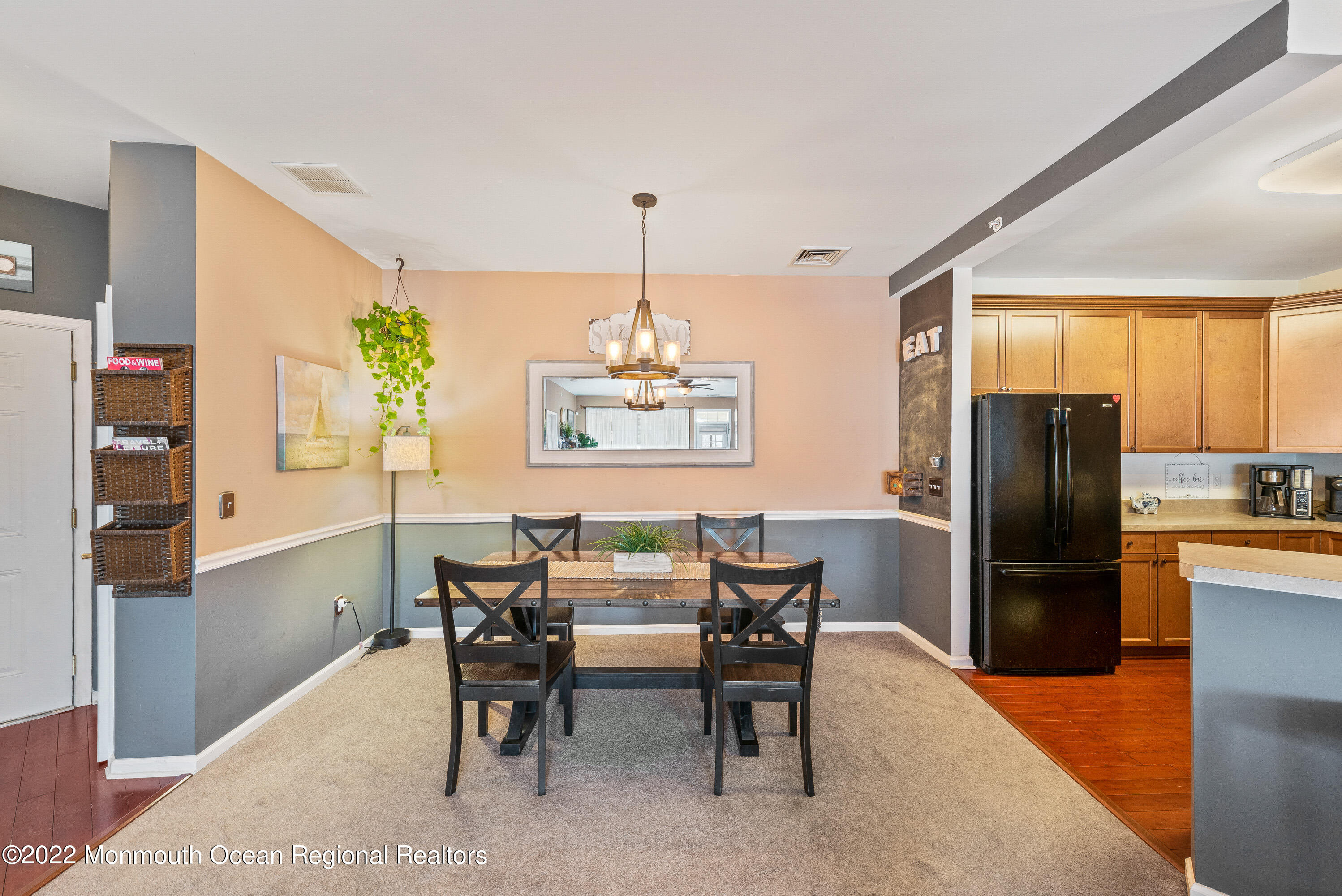 136 Mill Pond Way, Unit 22 Eatontown, NJ 07724 - Photo 12 of 29 a dining room with furniture a chandelier and wooden floor