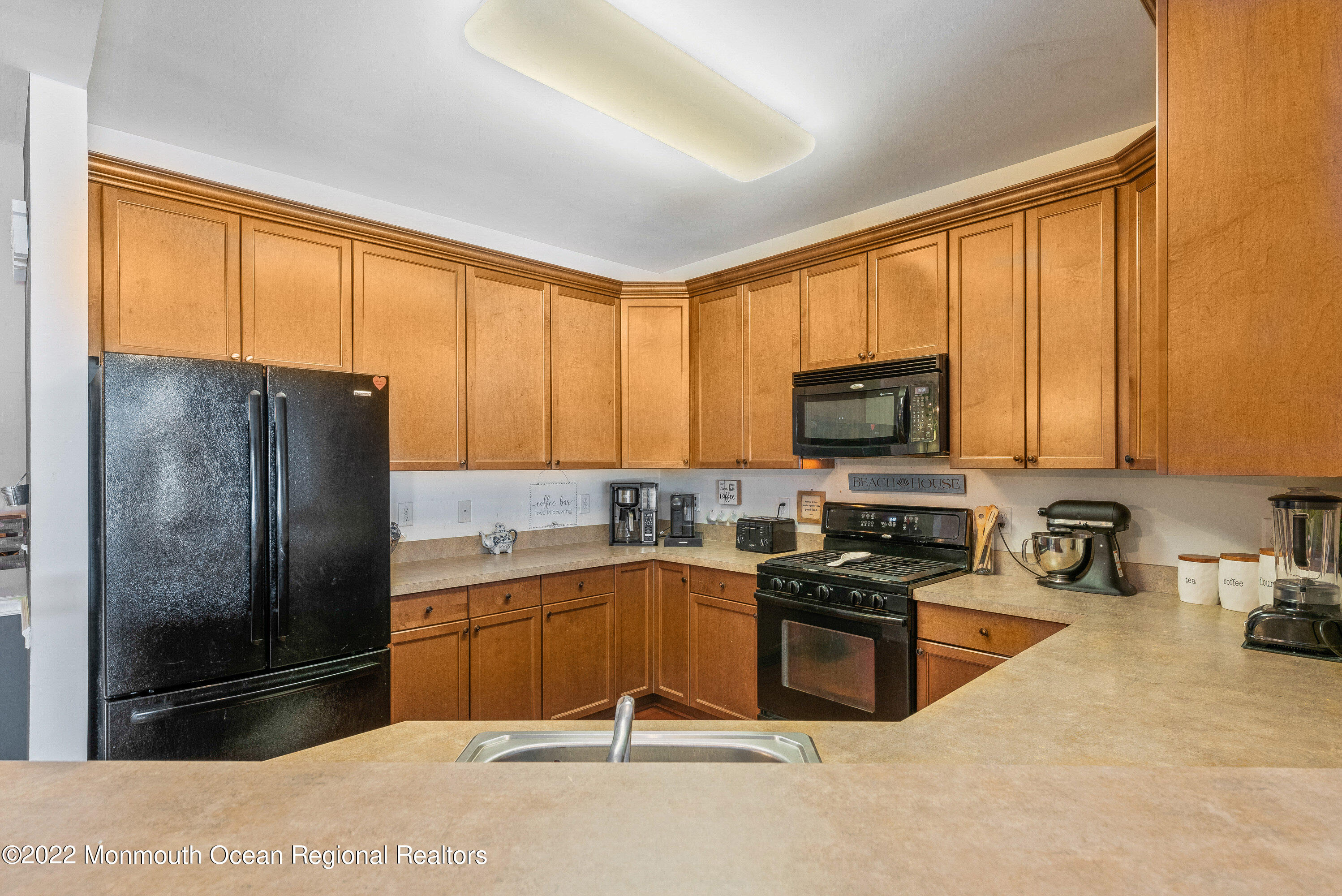 136 Mill Pond Way, Unit 22 Eatontown, NJ 07724 - Photo 16 of 29 a kitchen with stainless steel appliances granite countertop a refrigerator stove top oven a sink and dishwasher