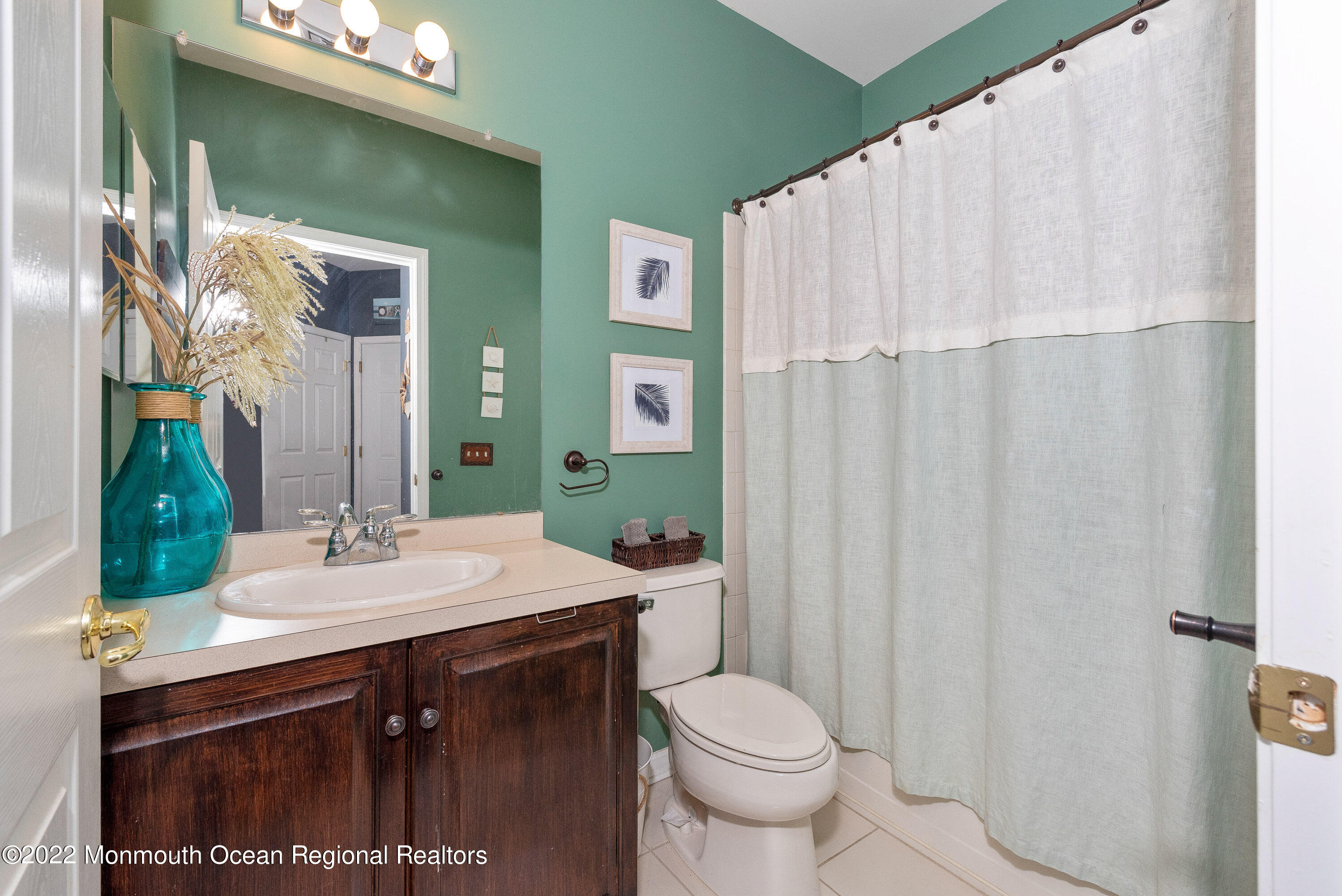 136 Mill Pond Way, Unit 22 Eatontown, NJ 07724 - Photo 26 of 29 a bathroom with a sink and a mirror