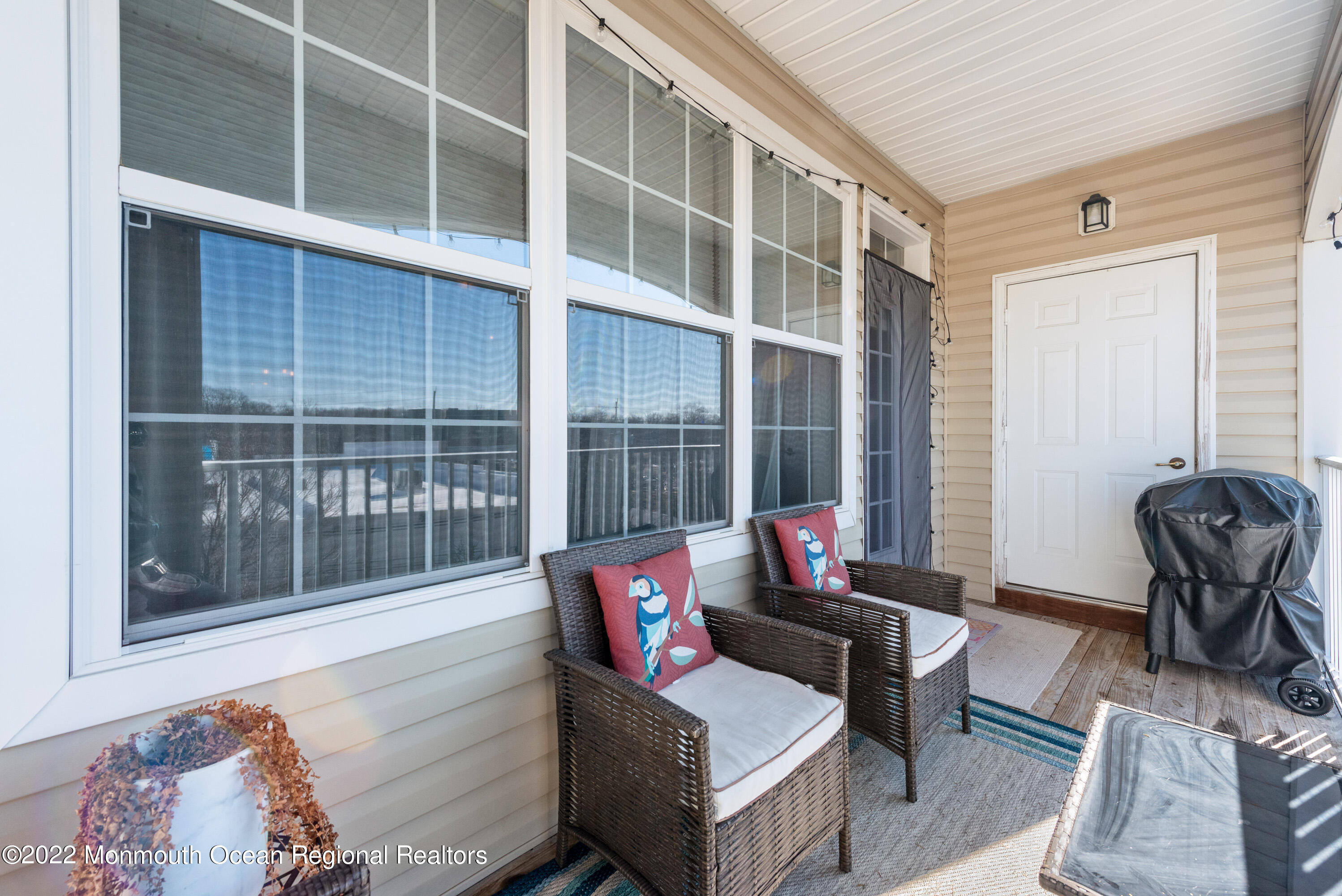 136 Mill Pond Way, Unit 22 Eatontown, NJ 07724 - Photo 28 of 29 a living room with furniture and a window
