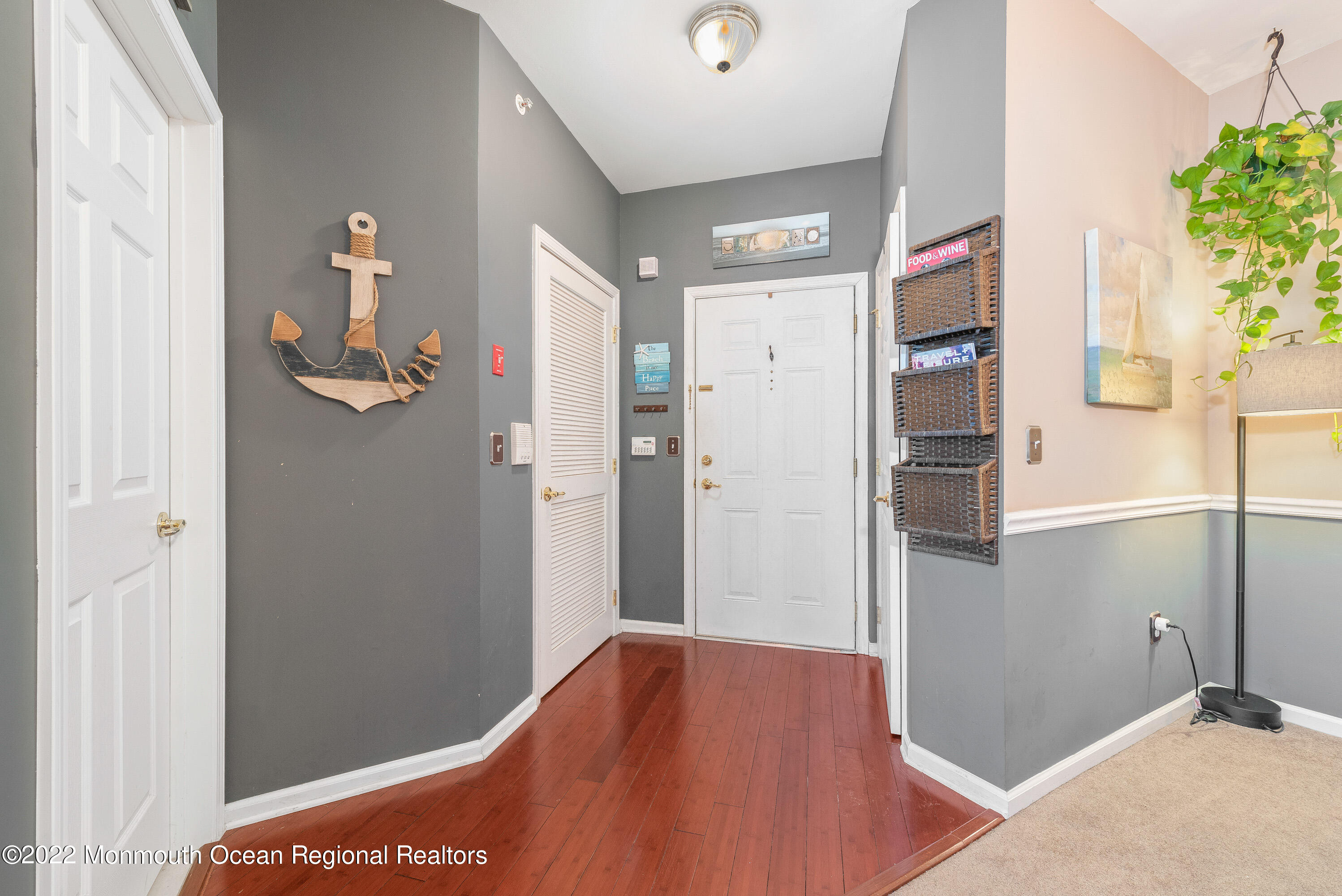 136 Mill Pond Way, Unit 22 Eatontown, NJ 07724 - Photo 5 of 29 a view of hallway with wooden floor