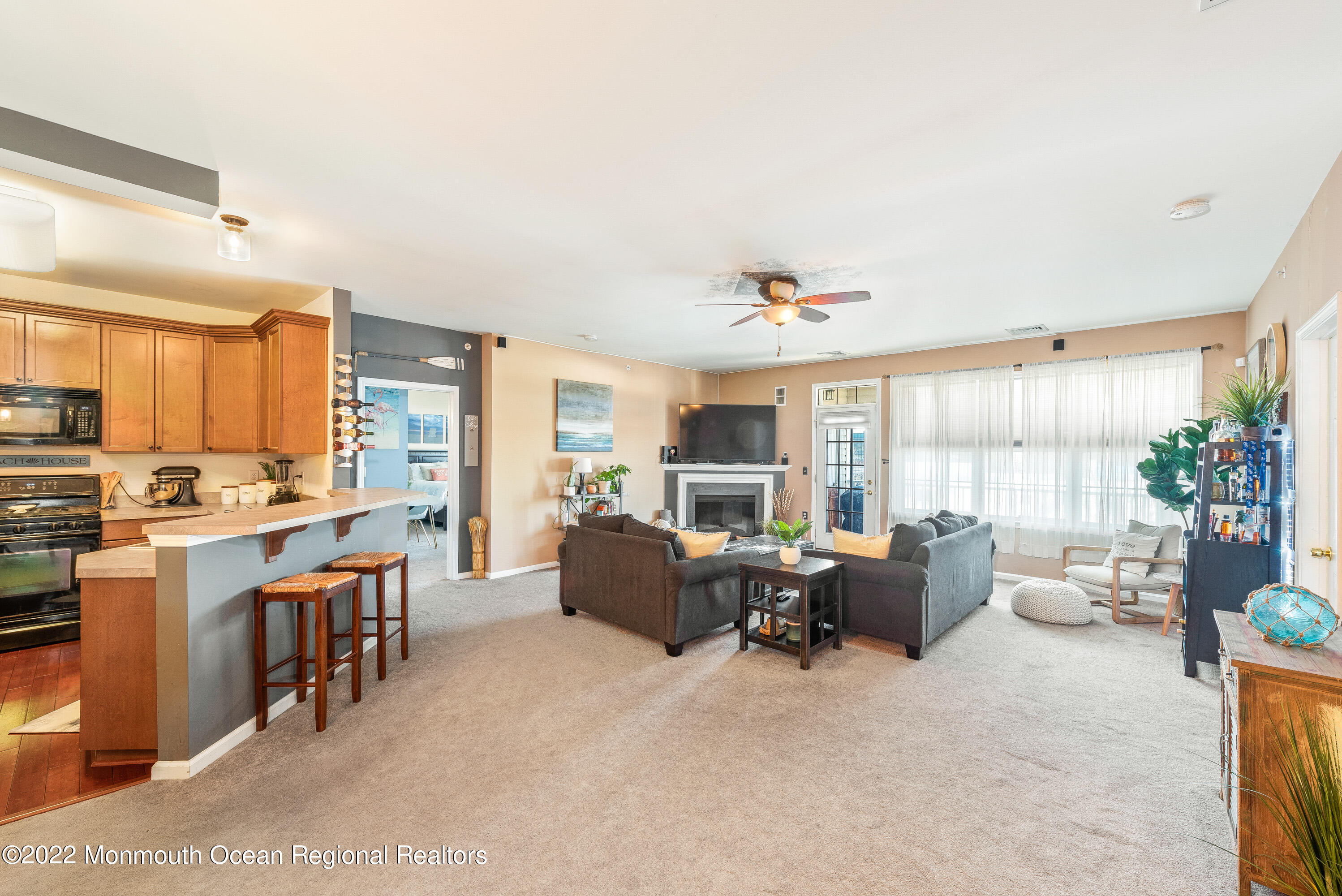 136 Mill Pond Way, Unit 22 Eatontown, NJ 07724 - Photo 7 of 29 a large living room with stainless steel appliances kitchen island granite countertop furniture and a large window