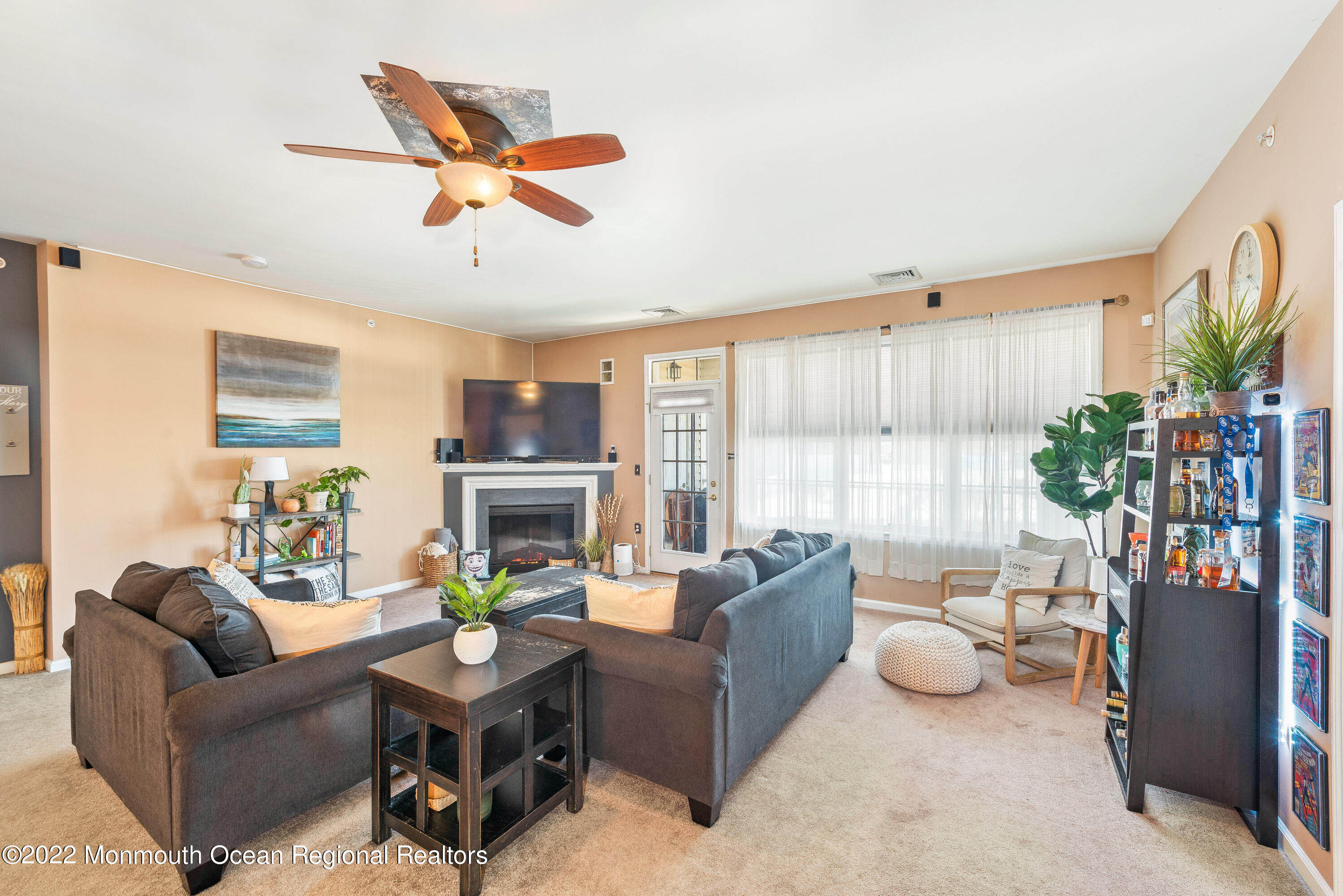 136 Mill Pond Way, Unit 22 Eatontown, NJ 07724 - Photo 8 of 29 a living room with furniture fireplace and a large window
