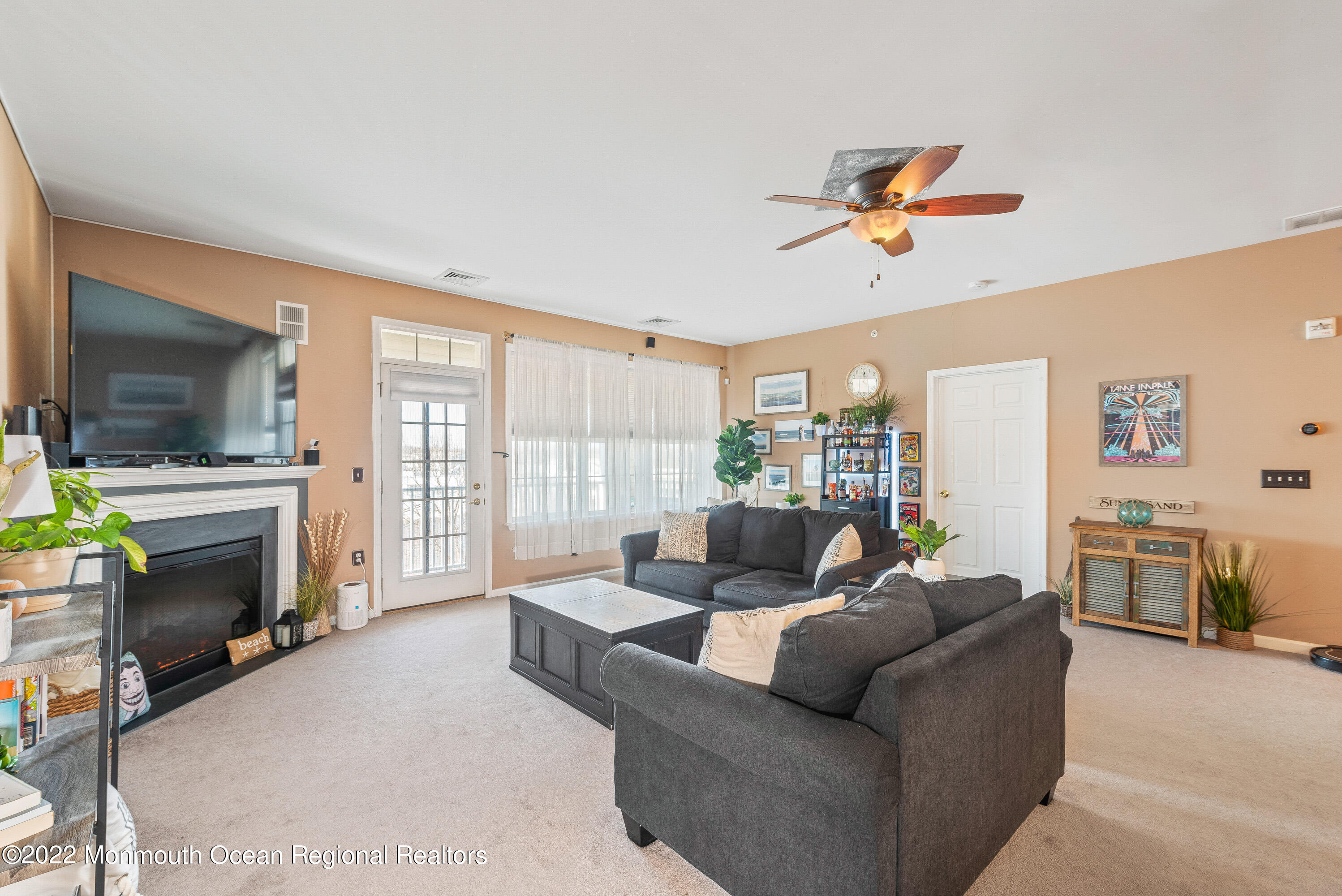 136 Mill Pond Way, Unit 22 Eatontown, NJ 07724 - Photo 9 of 29 a living room with furniture a fireplace and a flat screen tv