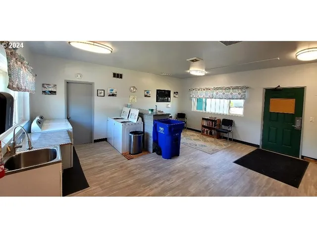 a backyard of a house with table and chairs