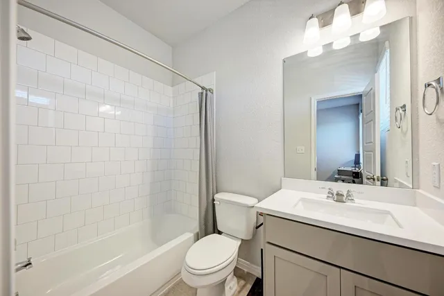 a bathroom with a sink a toilet and mirror