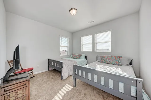 a bedroom with a bed a window and couch