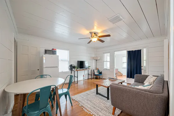 a living room with furniture and a chandelier
