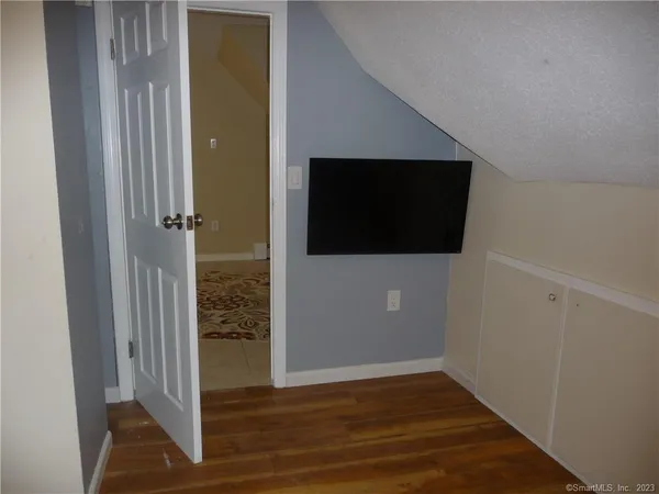 a view of a livingroom with an empty space and wooden floor