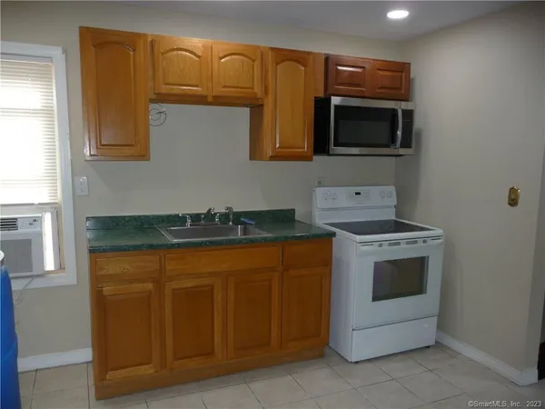 a kitchen with stainless steel appliances granite countertop a stove and a microwave