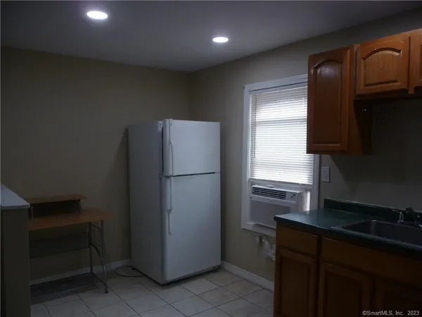 a kitchen with a refrigerator and a sink