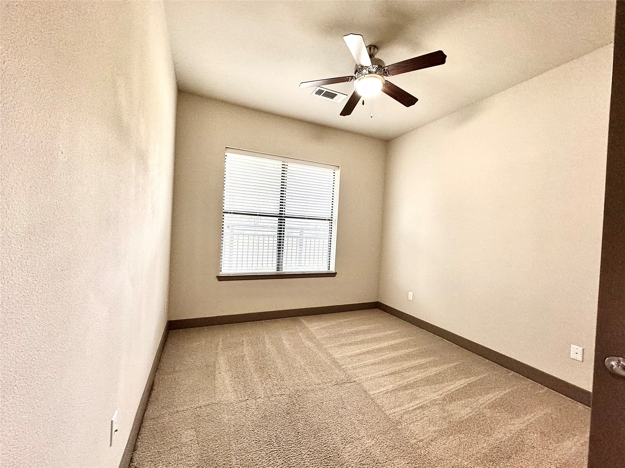 2033 South Gessner Road, Unit 2108 Houston, TX 77063 - Photo 7 of 21 an empty room with ceiling fan and windows
