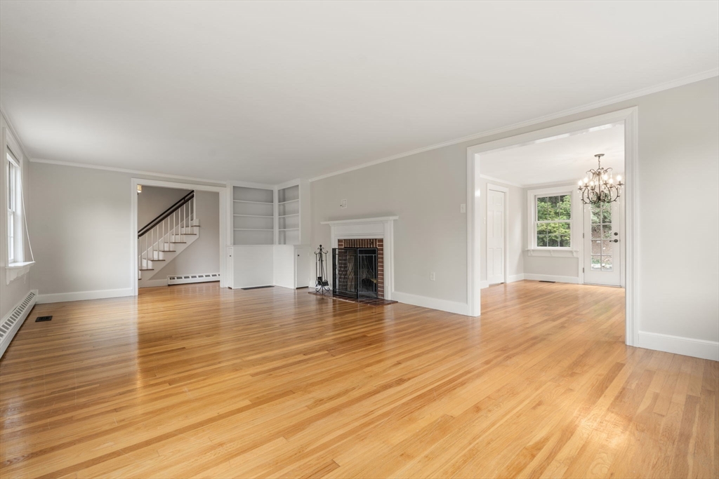 92 Abbot Street Andover, MA 01810 - Photo 13 of 35 a view of empty room with wooden floor and fireplace