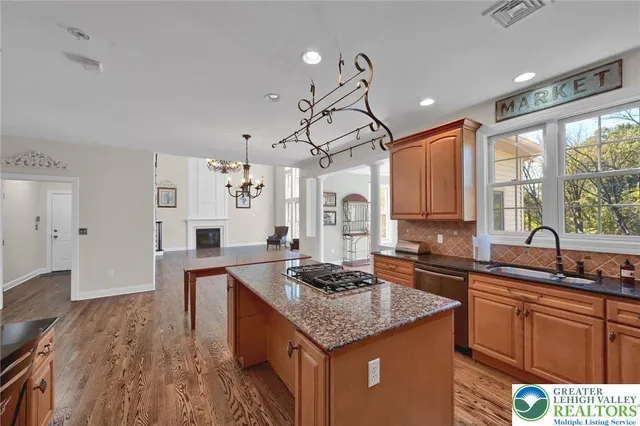 a view of a livingroom with wooden floor and furniture