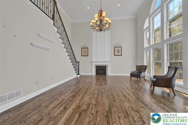 a dining room with furniture window and wooden floor