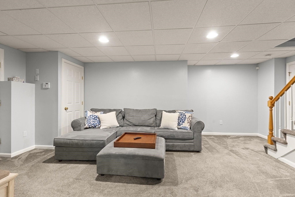 41 Chestnut Road Tyngsborough, MA 01879 - Photo 25 of 32 a living room with furniture and a flat screen tv