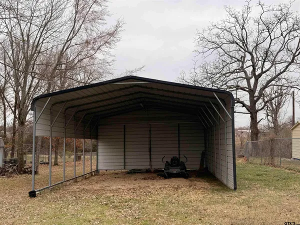 a view of backyard with cabin