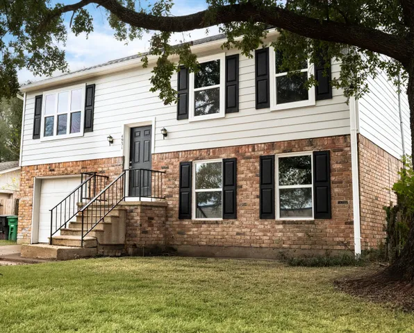 a view of a house with a small yard