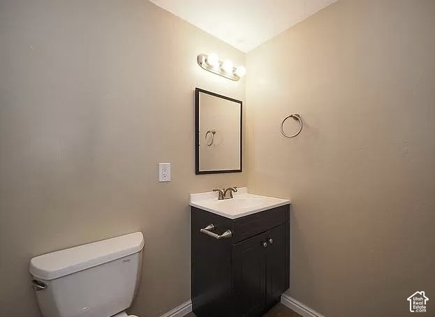 13548 South Villa Rosa Way Draper, UT 84020 - Photo 8 of 28 Vanity with dark wood-finish cabinetry, white countertop, and chrome faucet
