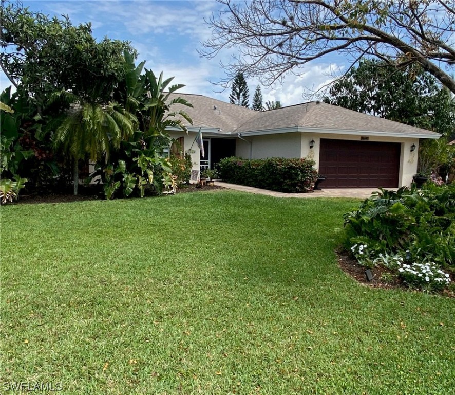 1113 Sand Castle Road Sanibel, FL 33957 - Photo 3 of 50 a front view of a house with garden