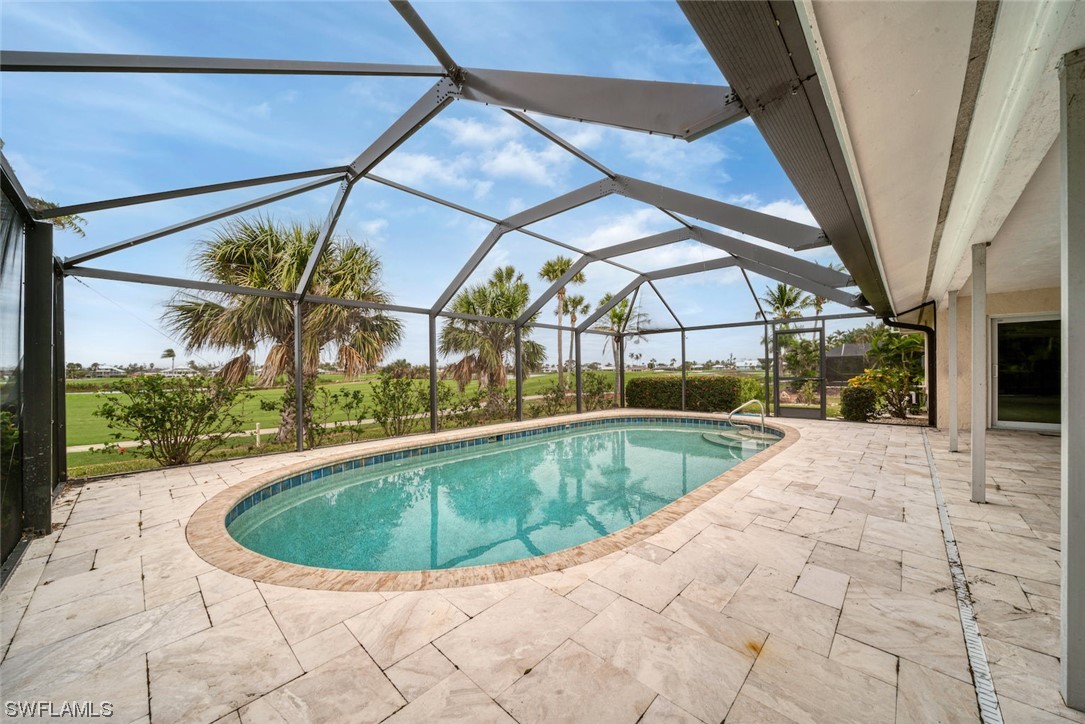 1113 Sand Castle Road Sanibel, FL 33957 - Photo 8 of 50 a view of a swimming pool with a yard
