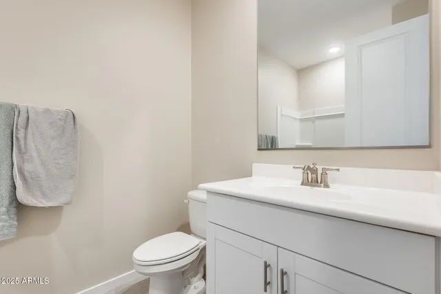 a bathroom with a sink toilet and a mirror