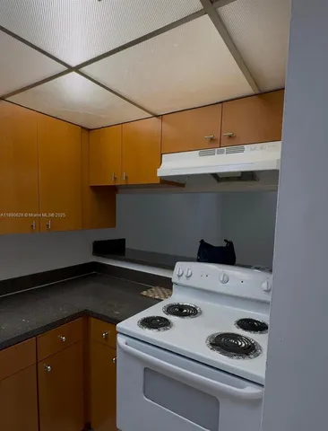 a kitchen with a stove and cabinets