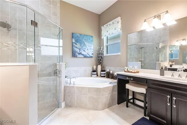 a bathroom with a sink a bathtub a mirror and a shower