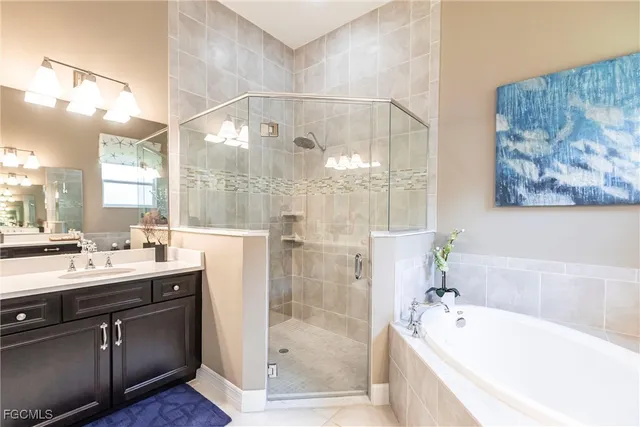 a bathroom with a tub sink and mirror