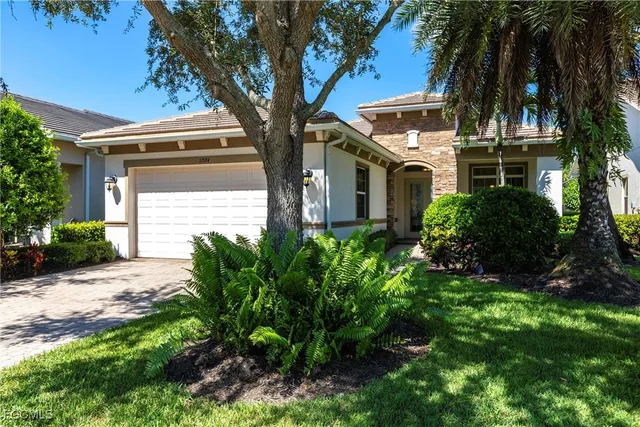 a view of a house with a large tree