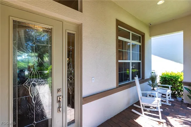 a balcony with furniture and a potted plant
