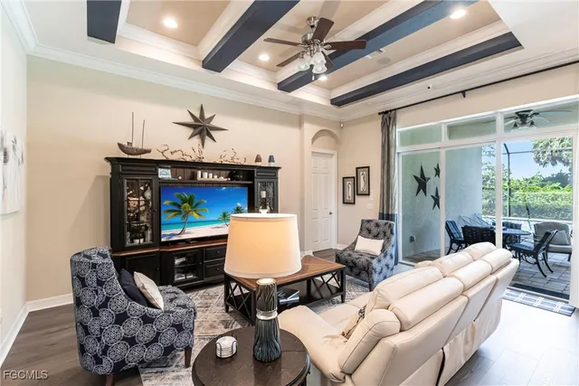 a living room with furniture a window and a ceiling fan