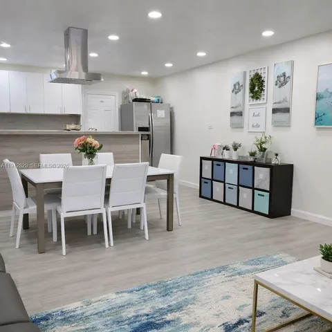 a view of kitchen with refrigerator microwave and wooden floor