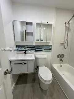 a bathroom with a sink a toilet and mirror