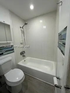 a bathroom with a granite countertop toilet a sink and bathtub