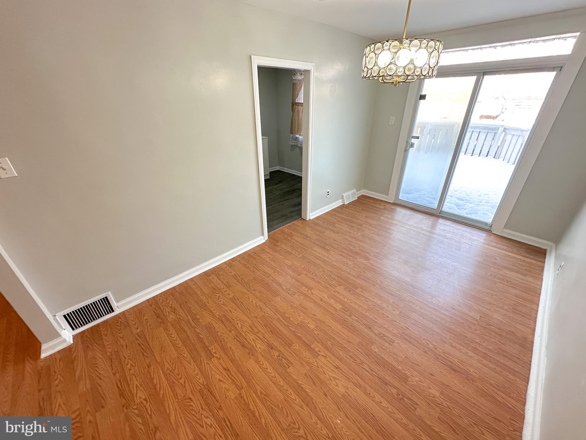 217 Stevens Street Philadelphia, PA 19111 - Photo 5 of 18 a view of an empty room with wooden floor and a window