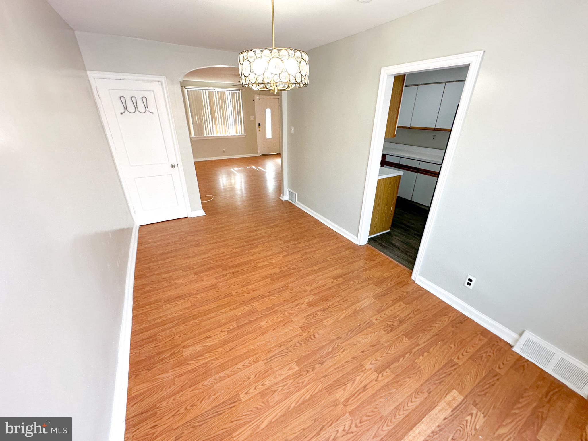 217 Stevens Street Philadelphia, PA 19111 - Photo 6 of 18 a view of a room with wooden floor and chandelier