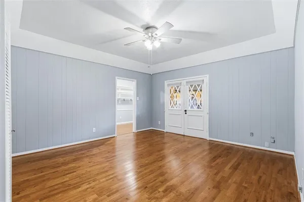 an empty room with fan and windows