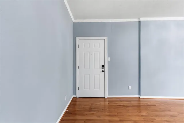 a view of a room with wooden floor