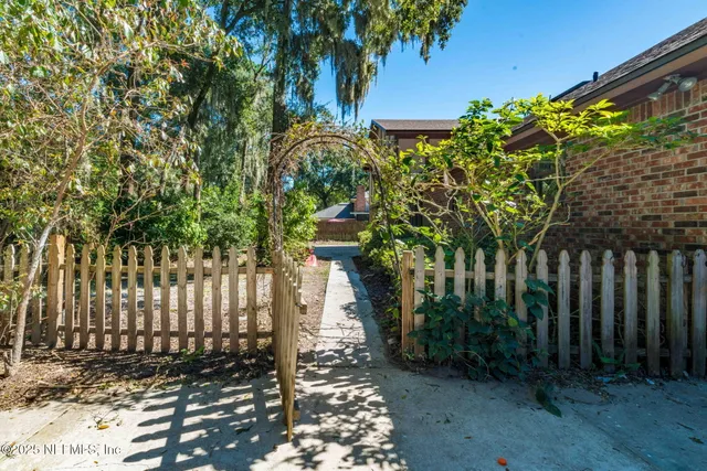a view of a hallway with wooden floor and entryway