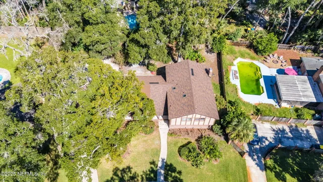 a kitchen with granite countertop white cabinets and stainless steel appliances