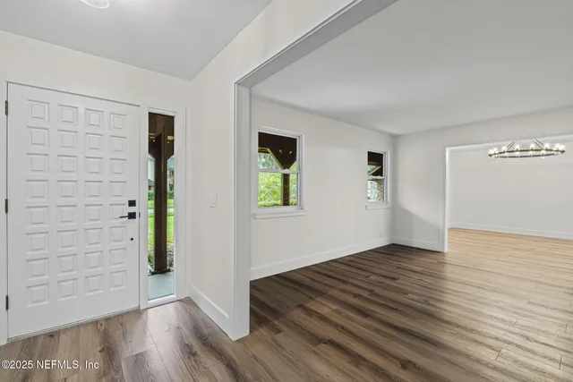 a view of entryway and hall with wooden floor