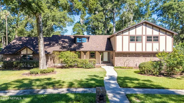 an aerial view of a house with a yard and garden