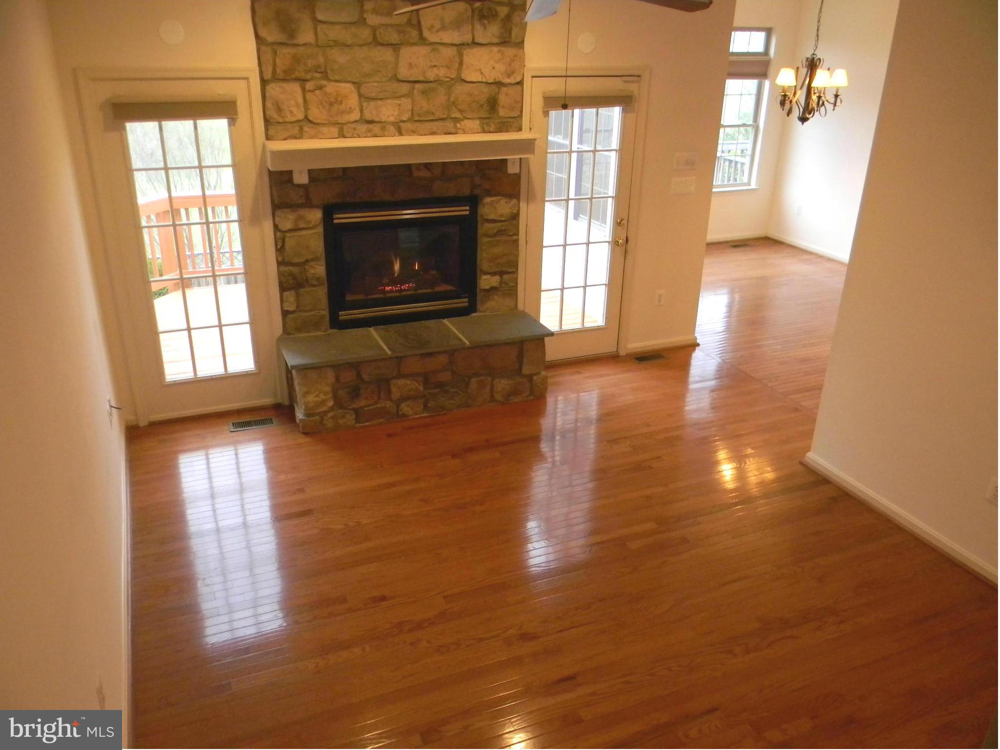 2442 Rippling Brook Road Frederick, MD 21701 - Photo 14 of 30 a view of a livingroom with wooden floor and a fireplace
