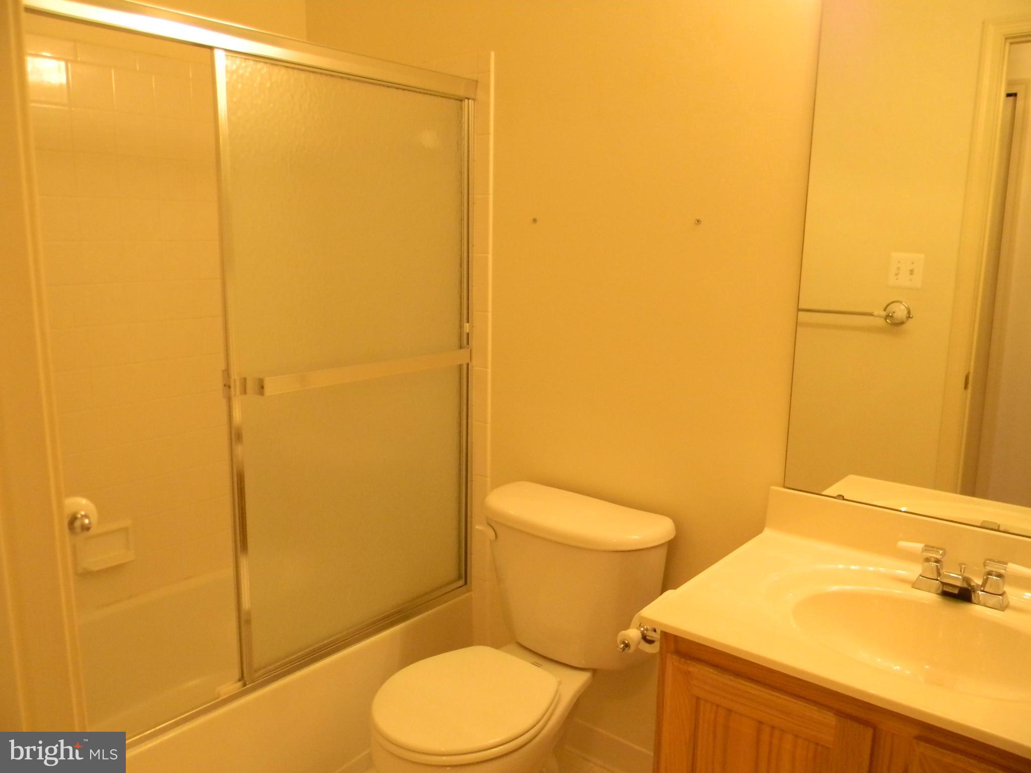 2442 Rippling Brook Road Frederick, MD 21701 - Photo 22 of 30 a white toilet sitting next to a bathroom sink